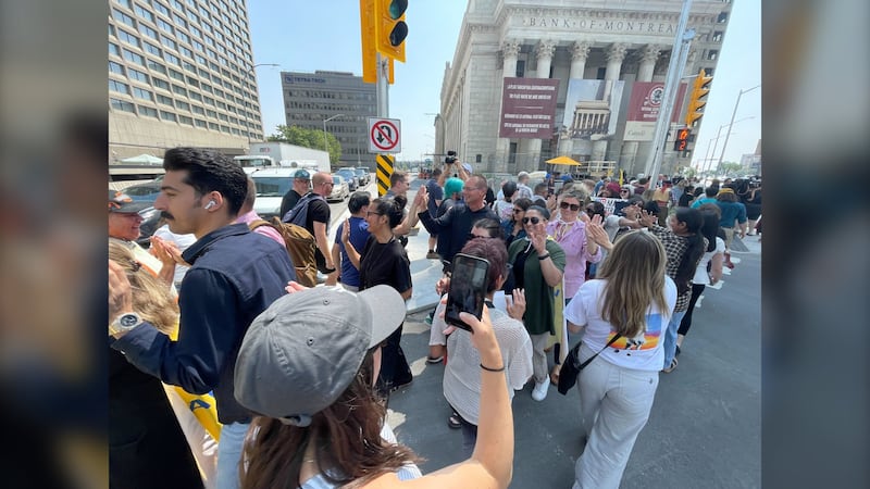 Winnipeggers high-five to celebrate reopening of Portage and Main